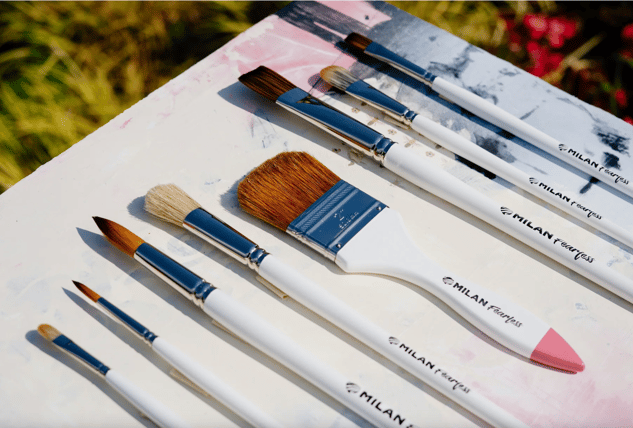 Paint brushes with white handels and brown and tan fibers